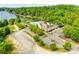 Aerial view showcasing a community pool and recreational area near the lake, surrounded by trees at 10033 Bora Bora Dv, Tega Cay, SC 29708