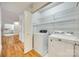 Bright laundry room with washer, dryer, and wire shelving at 10033 Bora Bora Dv, Tega Cay, SC 29708