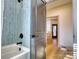Bathtub in updated bathroom with light blue tiles and modern fixtures at 1013 Oakmont Dr, Rock Hill, SC 29732
