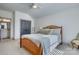 Cozy bedroom with wood bed frame, ceiling fan, and adjoining bathroom at 1013 Oakmont Dr, Rock Hill, SC 29732