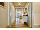 Hallway with hardwood floors, an ornate mirror, an entry table, and a glimpse into a living room at 1013 Oakmont Dr, Rock Hill, SC 29732