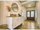 Bright foyer featuring hardwood floors, an ornate mirror, an entry table, and a stylish light fixture at 1013 Oakmont Dr, Rock Hill, SC 29732
