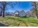 Wide view of the house with a black wood fence, a well-manicured lawn and beautiful landscaping at 1013 Oakmont Dr, Rock Hill, SC 29732