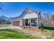 Charming home featuring a one car garage, rock landscaping, a gray roof, and a welcoming front porch with rocking chairs at 1013 Oakmont Dr, Rock Hill, SC 29732