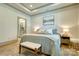 Comfortable main bedroom featuring a light blue quilt, bench, stylish decor, and natural light at 1013 Oakmont Dr, Rock Hill, SC 29732