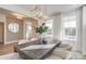 Bright dining room featuring a decorative light fixture, white trim, neutral paint, and two windows at 1049 Kinship Dr # 77, Lancaster, SC 29720
