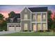 Charming two-story home with a welcoming front porch, attached two-car garage, and landscaped yard at 1049 Kinship Dr # 77, Lancaster, SC 29720