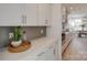 Bright kitchen features white cabinets, gray backsplash, and quartz countertops at 1049 Kinship Dr # 77, Lancaster, SC 29720