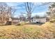 Expansive backyard features a greenhouse and ample space for gardening and recreation at 1061 Gaither Nw Pl, Concord, NC 28027