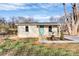 Charming bungalow with a covered front porch and lovely landscaping and a walkway to the driveway at 1061 Gaither Nw Pl, Concord, NC 28027