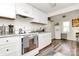 Well-lit kitchen with white appliances and cabinets, creating a clean and inviting space at 1061 Gaither Nw Pl, Concord, NC 28027