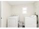 Bright laundry room features washer, dryer, and a small window for natural light at 1061 Gaither Nw Pl, Concord, NC 28027
