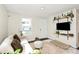 Bright living room featuring white walls, wood floors, a couch and built in shelves and plenty of natural light at 1061 Gaither Nw Pl, Concord, NC 28027