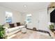 Bright living room featuring white walls, wood floors, a couch and a charming decor at 1061 Gaither Nw Pl, Concord, NC 28027