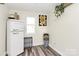 Small room with wood floors and vintage refrigerator at 1061 Gaither Nw Pl, Concord, NC 28027