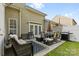 Backyard patio features an outdoor seating area with a sofa, table, grill, and a cozy rug at 11141 Lions Mane St, Charlotte, NC 28273