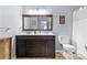 Bathroom featuring a wooden vanity with drawers, a mirror, and a toilet at 11141 Lions Mane St, Charlotte, NC 28273