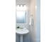 Well-lit bathroom with a pedestal sink, modern fixtures, and a clean, minimalist design at 11440 Westbranch Pkwy, Davidson, NC 28036