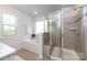 Bathroom showcasing a separate tub and shower, with a tiled surround and glass enclosure at 11440 Westbranch Pkwy, Davidson, NC 28036