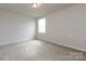 Bedroom featuring neutral walls, carpet, and natural light from a window at 11440 Westbranch Pkwy, Davidson, NC 28036