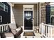 Inviting front porch featuring comfortable seating, a charming welcome mat, and decorative lanterns at 11440 Westbranch Pkwy, Davidson, NC 28036
