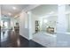 Hallway with dark floors leads to rooms with neutral walls and white trim, creating a bright, open feel at 11440 Westbranch Pkwy, Davidson, NC 28036