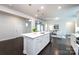 Open kitchen featuring a large island, stainless steel appliances, and dark wood flooring at 11440 Westbranch Pkwy, Davidson, NC 28036