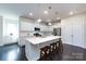 Modern kitchen with a spacious island, stainless steel appliances, and lots of white cabinets at 11440 Westbranch Pkwy, Davidson, NC 28036