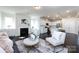 Open-concept living space with a fireplace and views of the modern kitchen at 11440 Westbranch Pkwy, Davidson, NC 28036