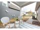 Covered patio with stylish seating, a small table, and views of the backyard at 11440 Westbranch Pkwy, Davidson, NC 28036