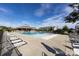 Large community swimming pool surrounded by lounge chairs and a covered clubhouse at 11440 Westbranch Pkwy, Davidson, NC 28036