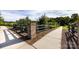 Scenic view of community walking trail featuring a brick pillar, wooden fence and trees at 11440 Westbranch Pkwy, Davidson, NC 28036