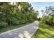 Well maintained, paved community walking trail, surrounded by lush greenery and trees at 11440 Westbranch Pkwy, Davidson, NC 28036