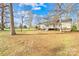 A sprawling backyard with mature trees offers plenty of space for recreation at 120 Roger Dr, Statesville, NC 28625