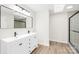 Modern bathroom featuring a double sink vanity, walk-in shower with glass door and a skylight at 120 Roger Dr, Statesville, NC 28625