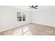 Bright bedroom with a ceiling fan, light wood floors, and a large window that lets in plenty of natural light at 120 Roger Dr, Statesville, NC 28625