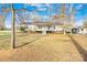 Charming single-story home with a front porch, mature trees, and well-maintained landscaping at 120 Roger Dr, Statesville, NC 28625