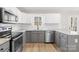 Updated kitchen featuring stainless steel appliances, granite countertops, and bright white cabinets at 120 Roger Dr, Statesville, NC 28625