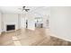 Bright living room featuring a fireplace, ceiling fan, and seamless flow into the kitchen at 120 Roger Dr, Statesville, NC 28625