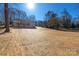 Spacious backyard with new straw and mature trees offering a serene outdoor escape at 1324 Southampton St, Shelby, NC 28152