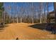 Backyard with straw offers great space and beautiful trees at 1324 Southampton St, Shelby, NC 28152