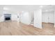 Finished basement with wood-look flooring, a blue-tiled fireplace, and access to other rooms via white doors at 1324 Southampton St, Shelby, NC 28152