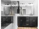 Modern bathroom featuring double vanity with gold hardware and a glass-enclosed shower with striking black tile at 1324 Southampton St, Shelby, NC 28152