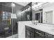 Modern bathroom with sleek double vanity, quartz countertops and black tile, glass shower enclosure with gold fixtures at 1324 Southampton St, Shelby, NC 28152
