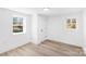 Bright bedroom with modern flooring, dual windows, and a fresh, neutral palette, creating a calm and inviting space at 1324 Southampton St, Shelby, NC 28152