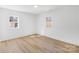 Sunlit bedroom features wood floors, neutral walls, and natural light pouring in from windows overlooking the outdoors at 1324 Southampton St, Shelby, NC 28152