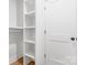 Bright, walk-in closet featuring custom shelving with ample storage space and a neutral color palette at 1324 Southampton St, Shelby, NC 28152