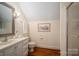 Cozy bathroom featuring a vanity with storage, a toilet, and a shower with glass doors at 1336 College Ave, Shelby, NC 28152