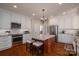 Modern kitchen with white cabinets, granite countertops, stainless steel appliances, and a central island with seating at 1336 College Ave, Shelby, NC 28152