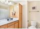 Well-lit bathroom with wooden cabinets, vanity, and modern fixtures at 13529 Browhill Ln, Charlotte, NC 28278